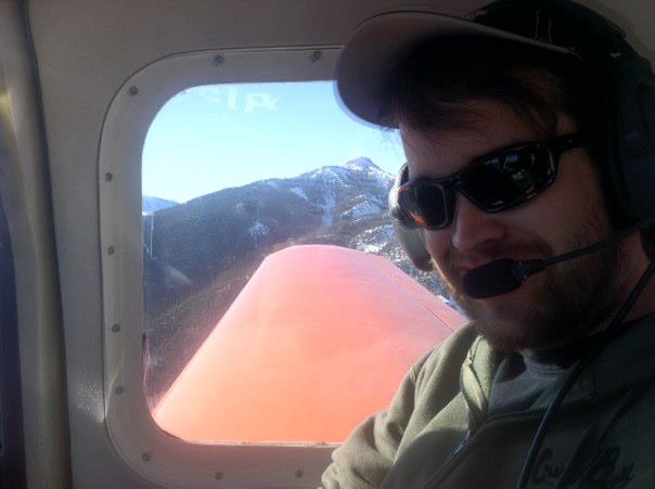 Pete on board Brian's Bellanca with Mt Crested Butte in background