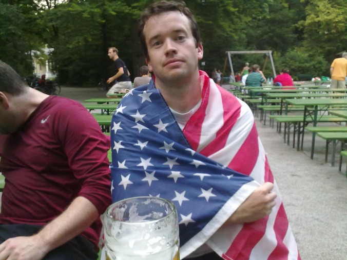 Pete at beergarden wrapped in American flag