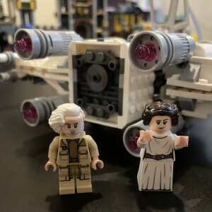 General Dodonna and Princess Leia minifigures standing in front of the rear of the X-Wing