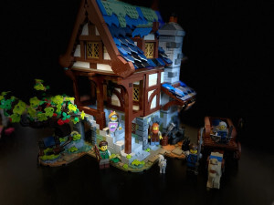 Lego Blacksmith medieval house with apple tree. Several minifigures, as well as a dog and a horse pulling a carriage stand around the house