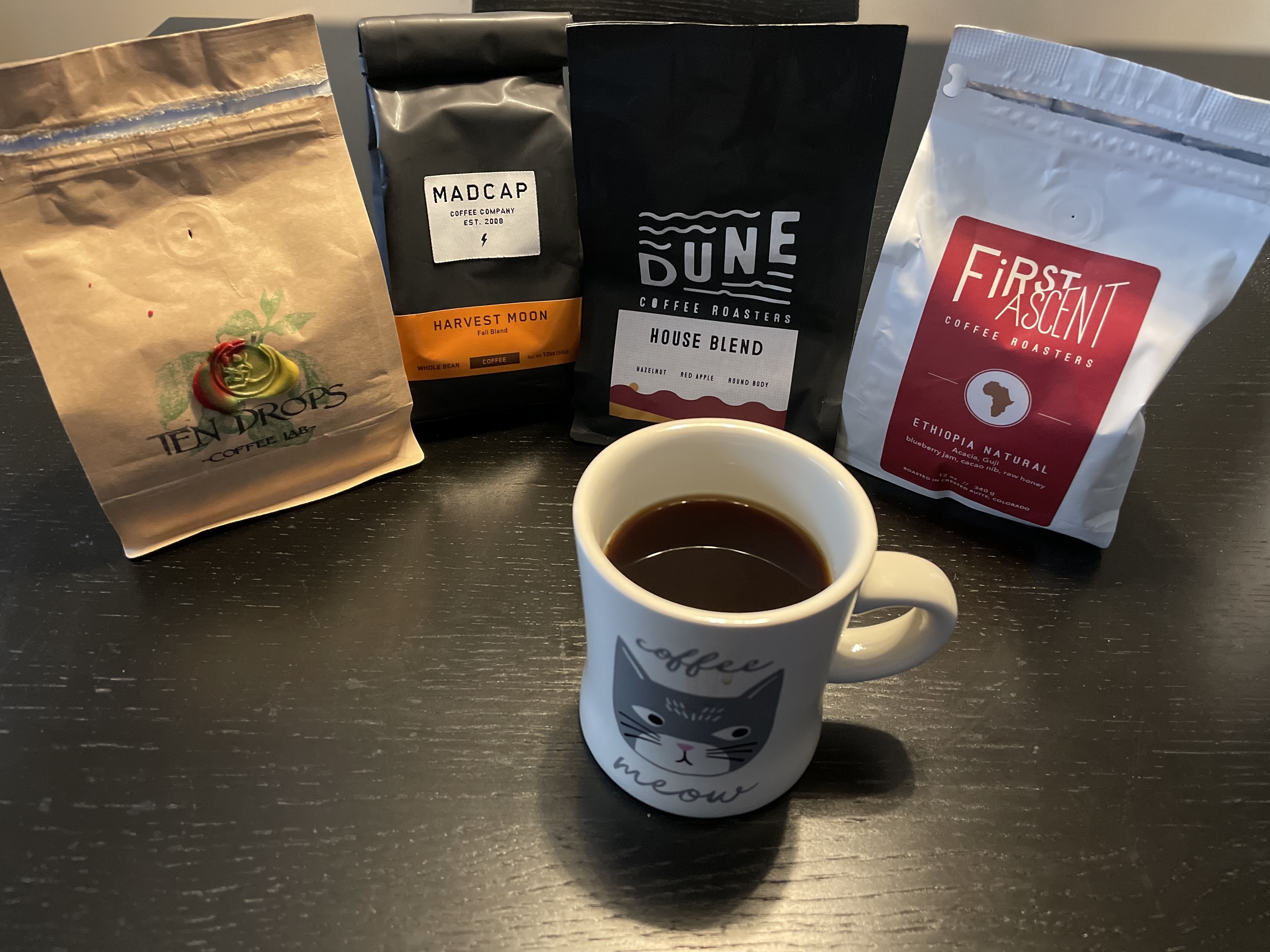 Four bags of coffee: Ten Drops, Madcap, Dune, and First Ascent