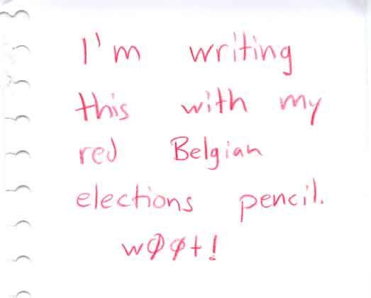 Piece of white paper with red handwriting that says "I'm writing this with my red Belgian elections pencil. w00t!"