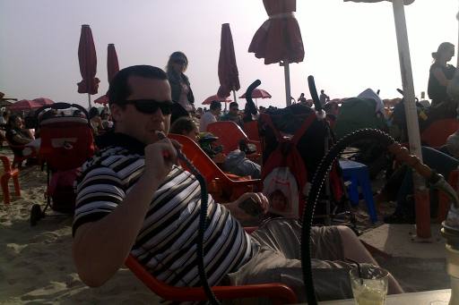 Pete sitting on the beach smoking a hookah