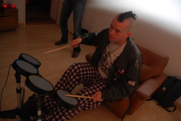Pete with a mohawk playing drumming video game
