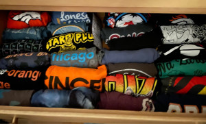 A neatly organized drawer of t-shirts